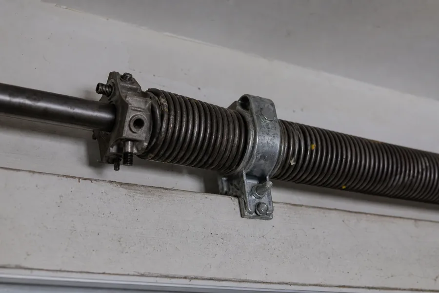 Torsion spring, winding cone and center bearing above a garage door in El Paso, TX